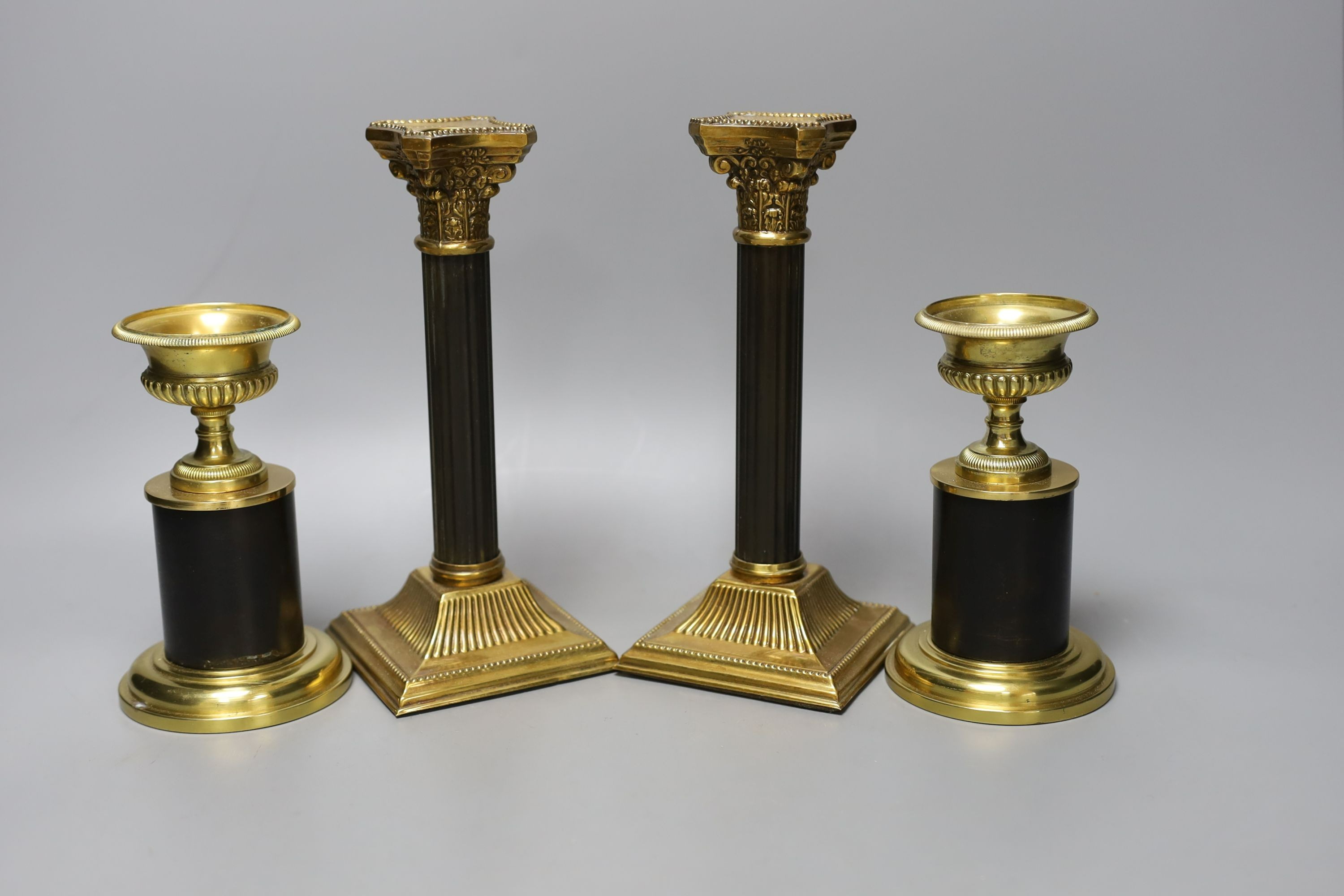 Two pairs of two-colour bronze or brass candlesticks, tallest 21cm